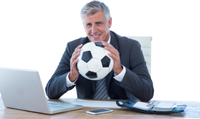 Smiling businessman holding soccer ball