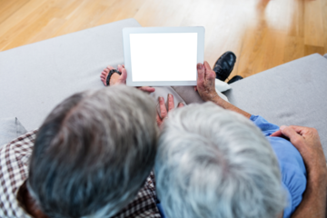 Senior couple holding digital tablet