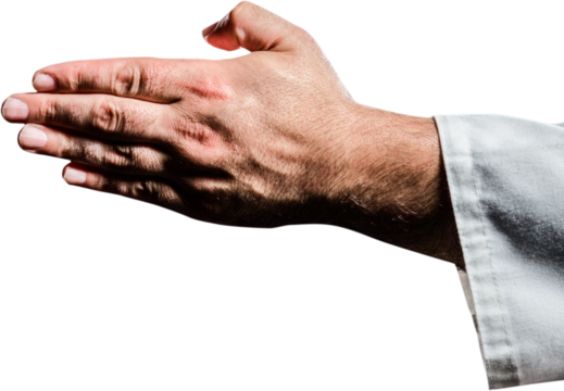Karate player making hand gesture on black background