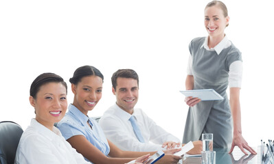 Portrait of smiling businesswoman with colleagues in conference