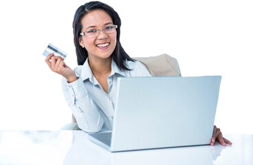 Smiling businesswoman holding credit card