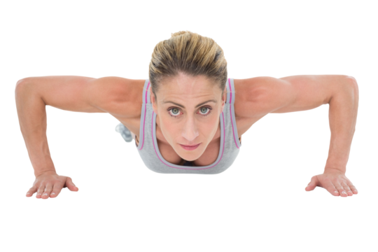 Strong woman doing press ups looking at camera - Powered by Adobe