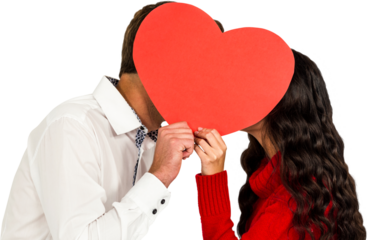 Couple covering faces with paper heart