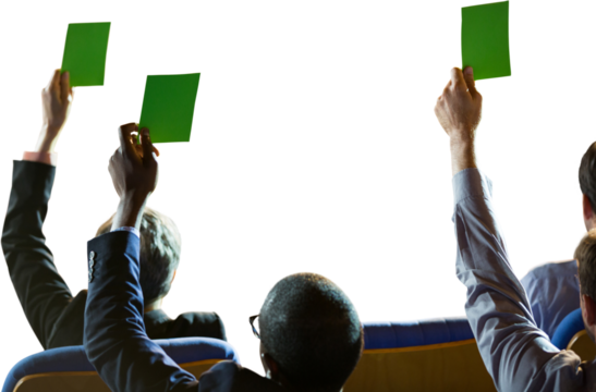 Rear view of business people holding paddles during auction