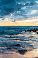 Sunrise with scattered rain clouds at the seaside