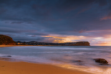 Sunrise with scattered rain clouds at the seaside
