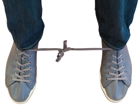 Man with shoelaces tied together