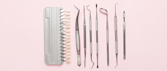 Dentist's tools and teeth color samples on light blue background