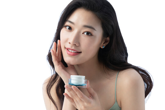 Young beautiful Chinese woman putting on make up