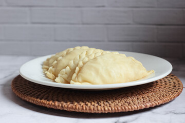 ready-to-cook raw kue pastel filled with vegetables and chicken