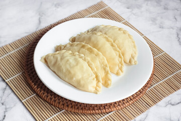 ready-to-cook raw kue pastel filled with vegetables and chicken