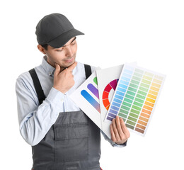 Thoughtful male painter with color palettes on white background