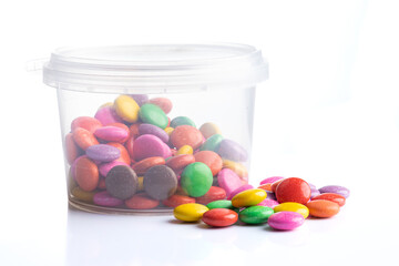 Multicolored candies in a jar isolated on a white background
