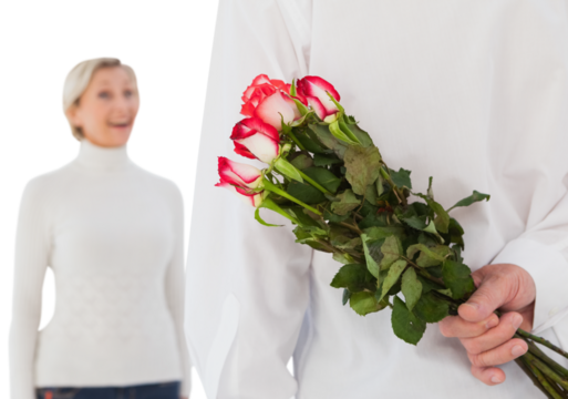 Man hiding bouquet of roses from older woman