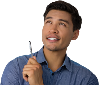 Businessman holding pen while looking away