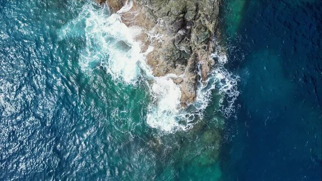 Astonishing View Of Turquoise Ocean Waves Splashing On Coastal Rocks At A Beach In Catanduanes, Philippines. aerial top view