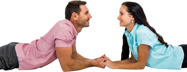 Obraz premium Smiling couple laying on the floor face to face holding hands