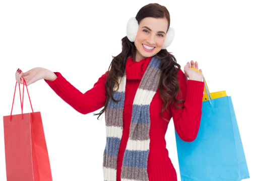 Brunette in winter clothes holding shopping bags - Powered by Adobe
