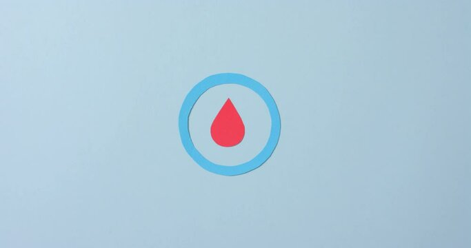 Close up of blood drop in blue circle on blue background, copy space, slow motion
