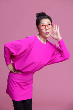 Studio shot of humorous senior Chinese woman