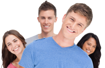 A man smiling with his head tilted and his friends behind him