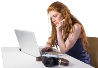 Pretty redhead working on laptop