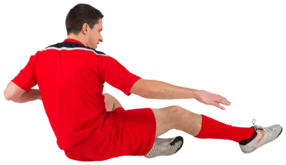 Tuinposter Fit football player jumping and kicking © vectorfusionart