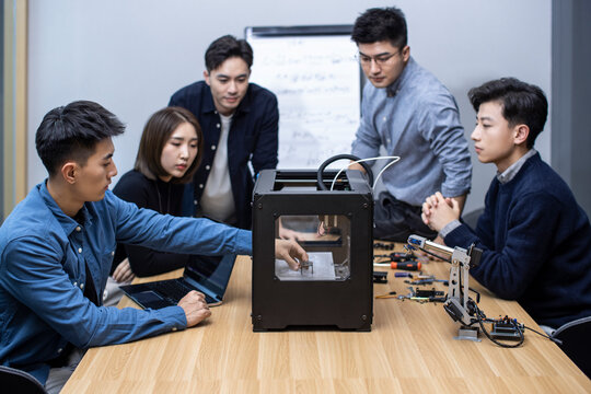 Confident Chinese designers using a 3D printer