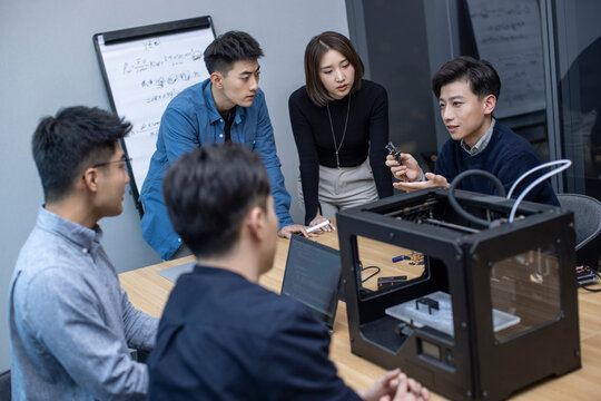 Confident Chinese designers using a 3D printer