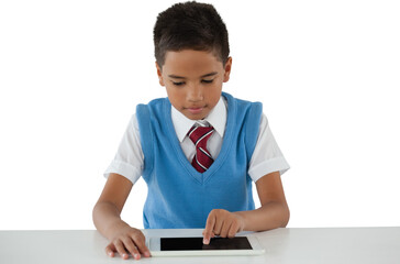 Schoolboy using digital tablet at table