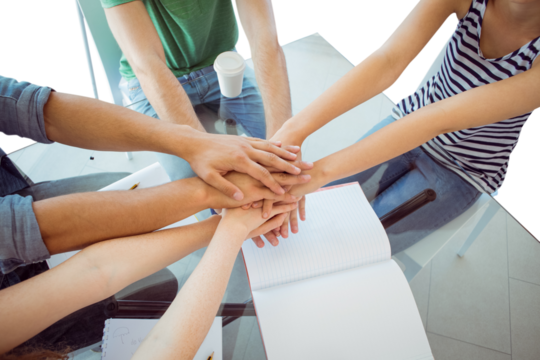 Fashion students putting hands together