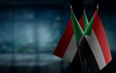 Small flags of the Sudan on an abstract blurry background