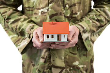 Mid section of soldier holding model home