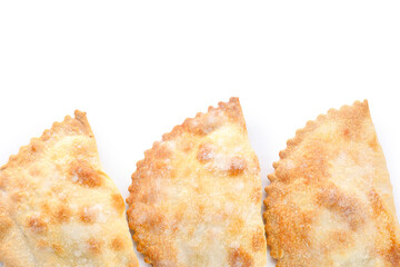 Baked meat empanadas on white background, closeup