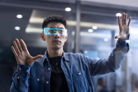 Young Chinese man wearing futuristic glasses