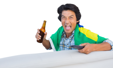 Football fan cheering while holding beer and remote