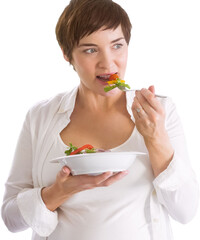 Beautiful pregnant woman eating salad
