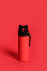 Pepper spray on red background