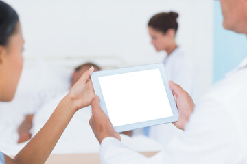 Doctors using digital tablet