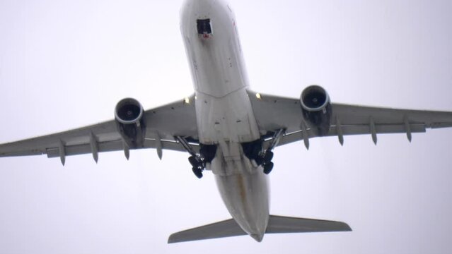 Airplane Retracting Landing Gear After Takeoff, Low Angle Slow Motion.