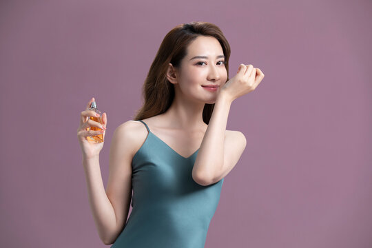 Beautiful young Chinese woman with perfume