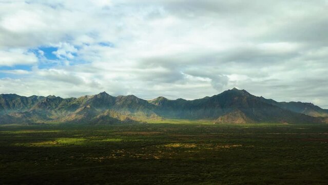 Aerial hyperlapse of clouds and shadows moving over the Sierra Estrella is a mountain range, in Arizona