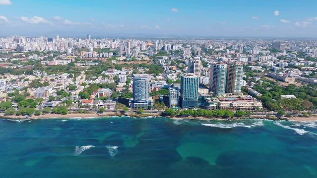 Panoramic aerial view from over ocean of Malecón and Santo Domingo skyline