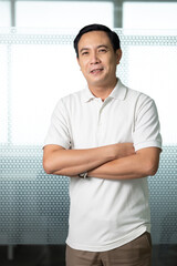 Portrait Asian business man standing look at camera  in modern office.