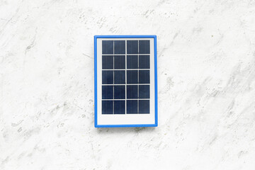 Portable solar panel on white grunge background
