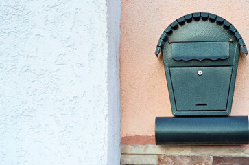 View of green mailbox on building wall