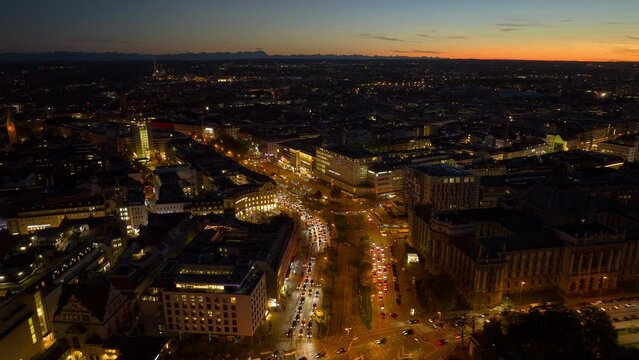 sunset night illumination munich city center traffic street square aerial panorama 4k timelapse germany