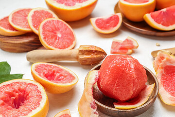 Fototapeta na wymiar Ripe juicy grapefruits on light table, closeup