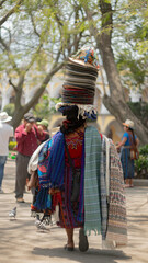 Fototapeta na wymiar Latin American entrepreneur woman from Guatemala with traditional fabrics and crafts