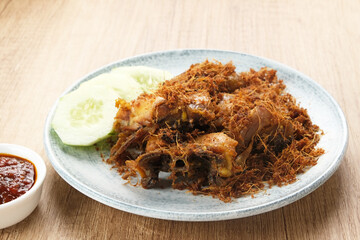 Ayam Goreng Lengkuas, fried chicken cooked with spices and sprinkled with grated galangal. Indonesian traditional food.  
